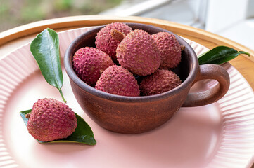 Cup of lychee. Rustic style. Litchi Sonn. Ripe lychees. Tropical fruits. Litchi chinensis