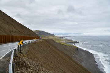 Scenic coastal road next to ocean in Iceland