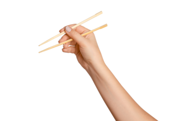 A woman's hand holds wooden chopsticks for sushi or rolls on a blank background.