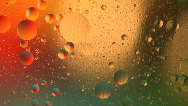 Multicolored abstract background of moving bubbles and planets in space. Macro photography.

