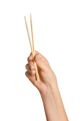A woman's hand holds wooden chopsticks for sushi or rolls on a blank background.