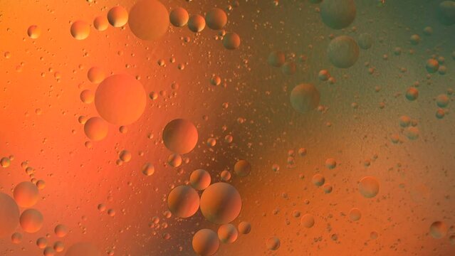 Multicolored abstract background of moving bubbles and planets in space. Macro photography.
