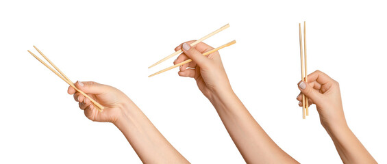 A set of female hands holding wooden chopsticks for sushi or rolls on a blank background. - Powered by Adobe