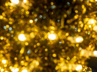 Yellow lights of blinking garland in blur. Festive mood