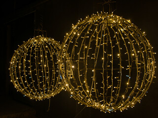 Close-up two large round LED glowing balls isolated on black background