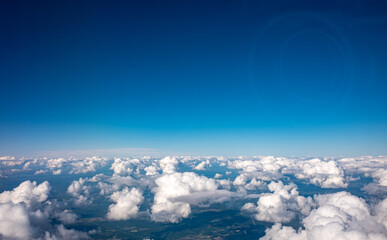 Fototapeta na wymiar View of small white clouds from the plane window