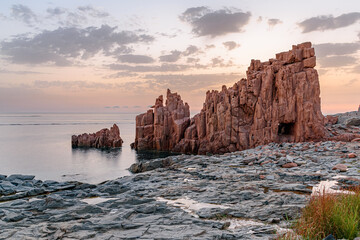 Geological feature called Rocce Rosse (red rocks) in Arbatax at the sunrise; east coast of...