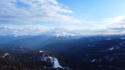 Fototapeta premium Elbrus region, huge, rocky mountain peaks covered with grass and snow, Kabardino-Balkaria