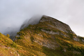 Fototapeta na wymiar Mountain peak in fog, fog shrouded a mountain peak, natural landscape
