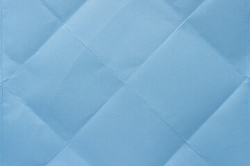 folded light blue crafting paper with diamond pattern crease folds