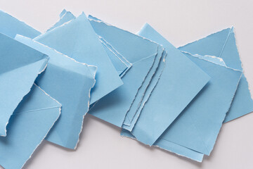 overlapping folded and torn light blue crafting paper tiles
