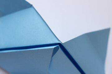 folded light blue crafting paper with triangle elements and 3d surfaces