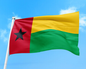 Guinea Bissau flag fluttering in the wind on sky.