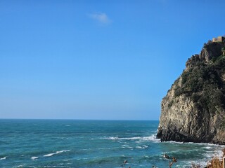 Corniglia, 5 Terre, Italy - January 05, 2024: Beautiful photography of the Cinque Terre landscape. Spectacular  view of the waves with blue sky in the background in winter days. 