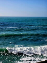 Fototapeta premium Corniglia, 5 Terre, Italy - January 05, 2024: Beautiful photography of the Cinque Terre landscape. Spectacular view of the waves with blue sky in the background in winter days. 