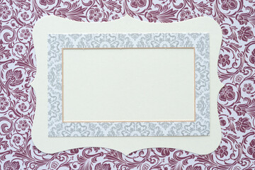 frame on card and decorative floral wallpaper