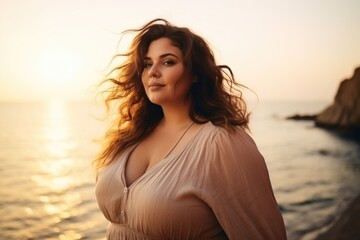 Fototapeta na wymiar Portrait of a beautiful brunette woman on the beach at sunset. AI generated