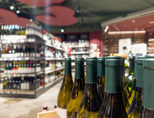 defocused alcohol (wine, champagne, liquor, whiskey) on store shelves