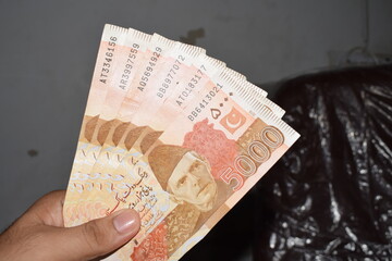 Close-up View of 5000 Pakistani Rupees Banknote Holding in Hand