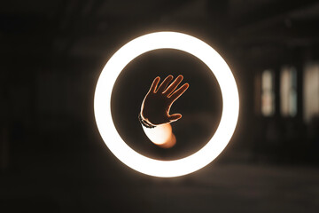 Halo portal ring light with hand reaching through, another dimension, alternate universe 