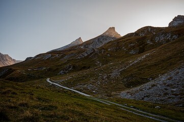 Landscape of the mountains, sky, forest and trail in autumn. Liddes, Valais Canton, Switzerland.