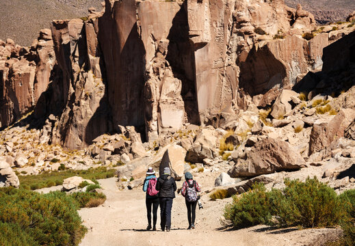 Tourists walk in the valley of stones. Bolivia. Altiplano Uyuni