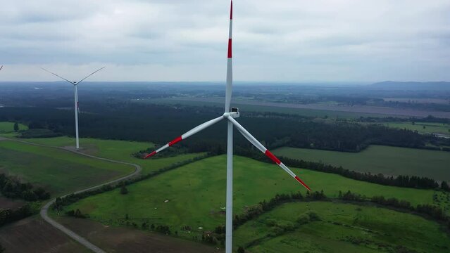 Close up of wind turbine. Aerial voew of wind mills farm park.