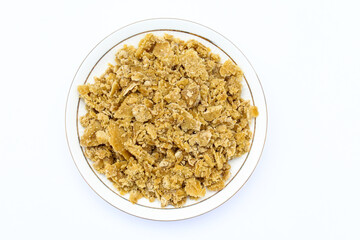 Jaggery in a plate on white background top view 