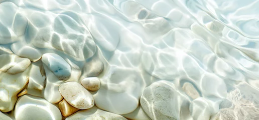 Tuinposter White stones with sun lights shadow in clear ripple water. Sea stones in the sea water. Pebbles under water. top view. abstract spa background concept banner for cosmetic care product.  © Viks_jin