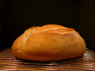 fresh home made loaf of bread on wooden table
