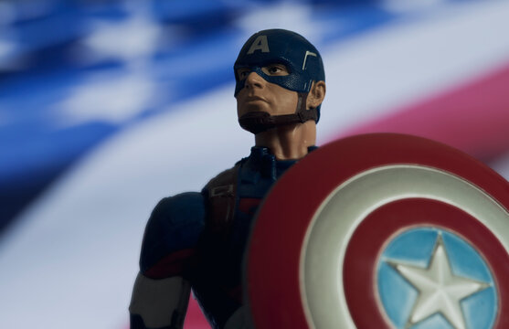 NEW YORK USA: AUGUST 7 2020: Portrait of Marvel comic superhero Captain America of the Avengers with USA flag - Hasbro action figure