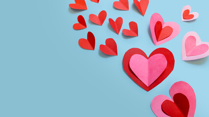 Beautiful paper hearts arranged on a sky-blue background. Greeting card concept for Valentine's Day. Mother's Day. copyspace