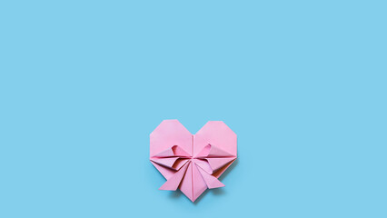 Pink paper hearts, origami, on a sky-blue background. Concept for Valentine's Day. Mother's Day.