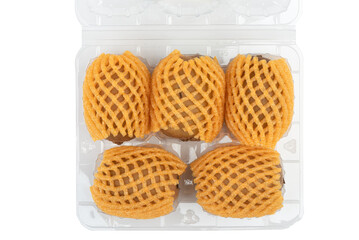 Top view of a kiwi in a plastic box and in nets to protect it from damage.