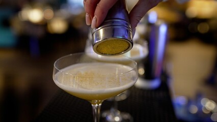 Close-up of a bartender's hands preparing cocktails. Hands of a female bartender preparing a cocktail close-up.
