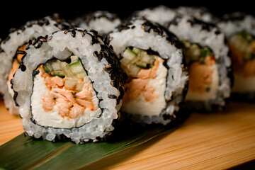 Sushi rolls with salmon, cucumber and cream cheese