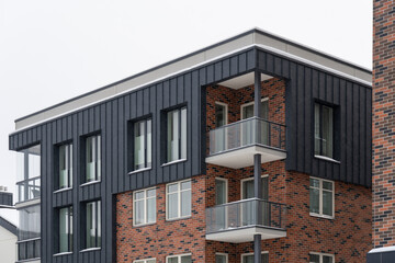 Selective focus to modern new apartments building at Pille street during winter time. Uus-Veereni, Tallinn, Estonia, Europe. December 2023