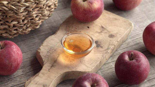 Pouring apple cider vinegar into a bowl