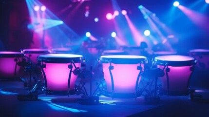 Conga drums illuminated by neon colorful stage lights. Can be used for musical event promotions or articles about live performances. Traditional percussion musical instrument of Afro-Cuban.