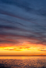 Big fluffy sunset clouds in summer. Orange and purple colors. Golden hour