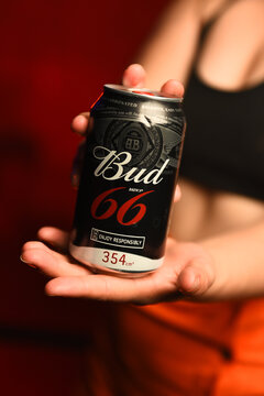 Bud 66 beer can in the hands of a woman.