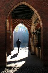 silhouette of a person walking in a mosque