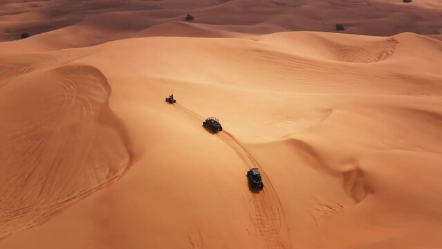 Dune buggy tour in Dubai desert dunes UAE aerial drone view