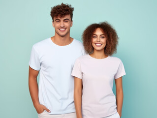 Fototapeta premium Portrait of couple in blank white shirts for mockup isolated on blue background