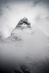 snow covered peak with fog 