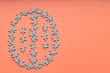 Brain Made of Puzzle Pieces on Orange Background, Copy Space