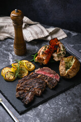 surf and turf, ribeye steak and lobster tail on black marble background