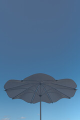 Fototapeta na wymiar White Shade Umbrella and Blue Sky