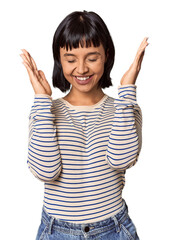 Young Hispanic woman with short black hair in studio joyful laughing a lot. Happiness concept.