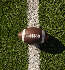 Top down view of an American Football resting on the goal line at a football stadium. Generic...